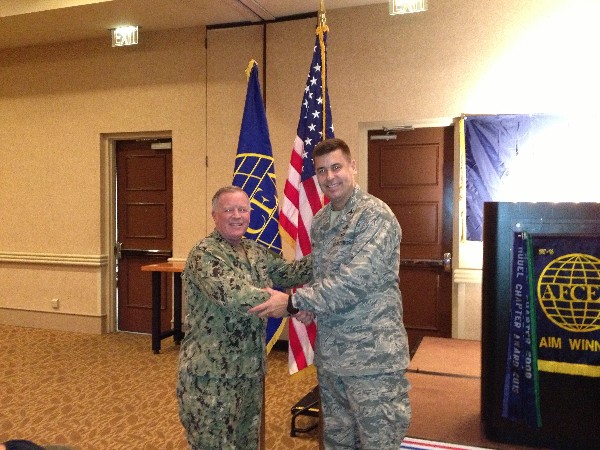 TAMPA-ST. PETERSBURG- Capt. Gerry Slevin, USN, chapter president (l), greets Col. Michael Hill, USAF, deputy director, communications systems, J-6 for Headquarters, United States Special Operations Command, speaker for the July luncheon.